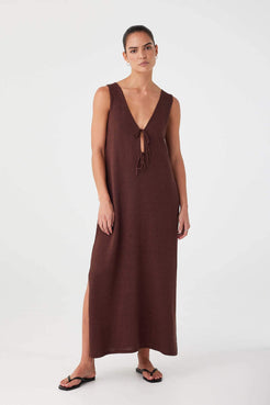 Model styled with tie side facing back. Sleeveless silhouette with soft drape and deep neckline at the rear.