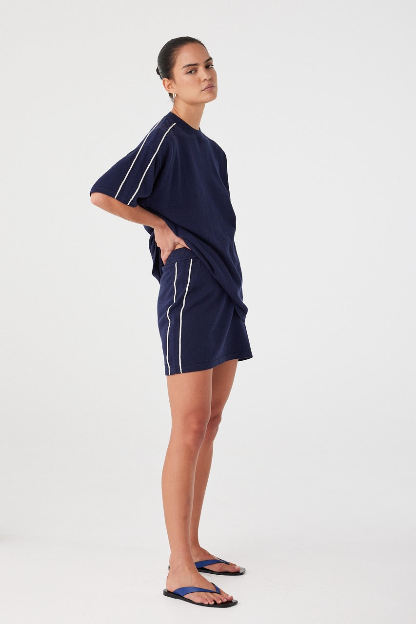 Model styled in navy oversized tee with dropped shoulders and soft volume. Natural fibre blend designed for off-duty layering.