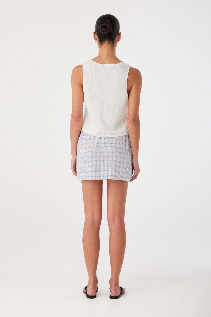 Back view of blue checked mini skirt with gathered waistband. Easy fit and breathable cotton fabric for summer ease.