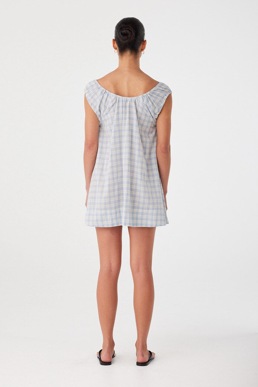 Back view of cotton check dress with relaxed silhouette. Unlined and breathable, designed for summer dressing.