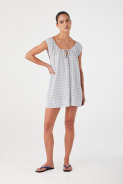 Model in flared mini dress with tie neckline and keyhole front. Powder blue check pattern in soft, airy cotton.