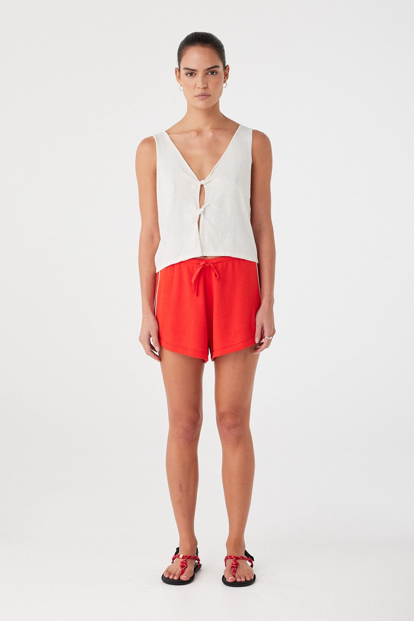 Cream linen cotton tank styled simply, with breathable shape and cutout detail.