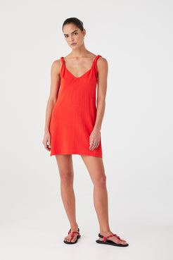 Bright red mini dress with semi-fitted shape and lightweight drape. Designed for warm days and elevated simplicity.