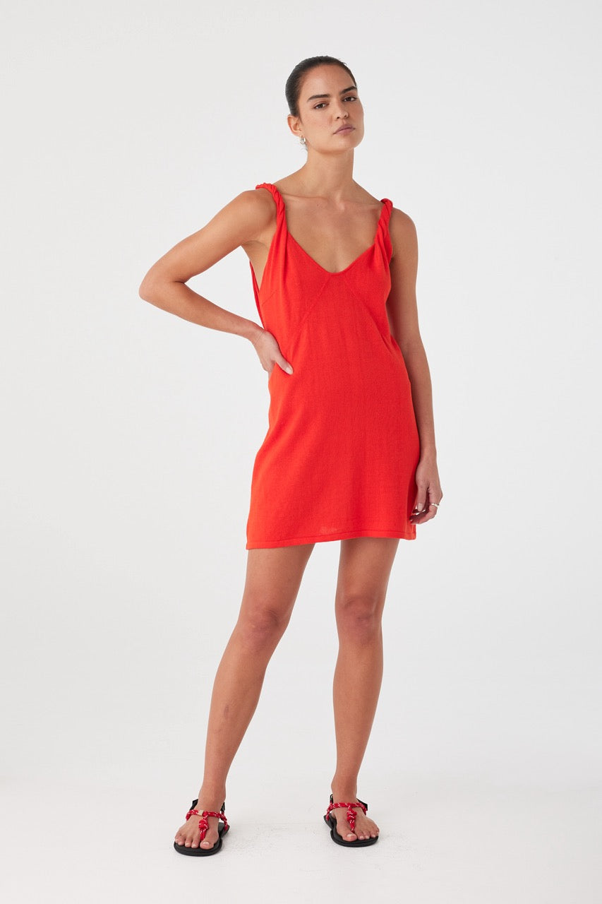 Hibiscus red dress with V neckline and soft structure. Styled for warm-weather ease in breathable natural fibres.