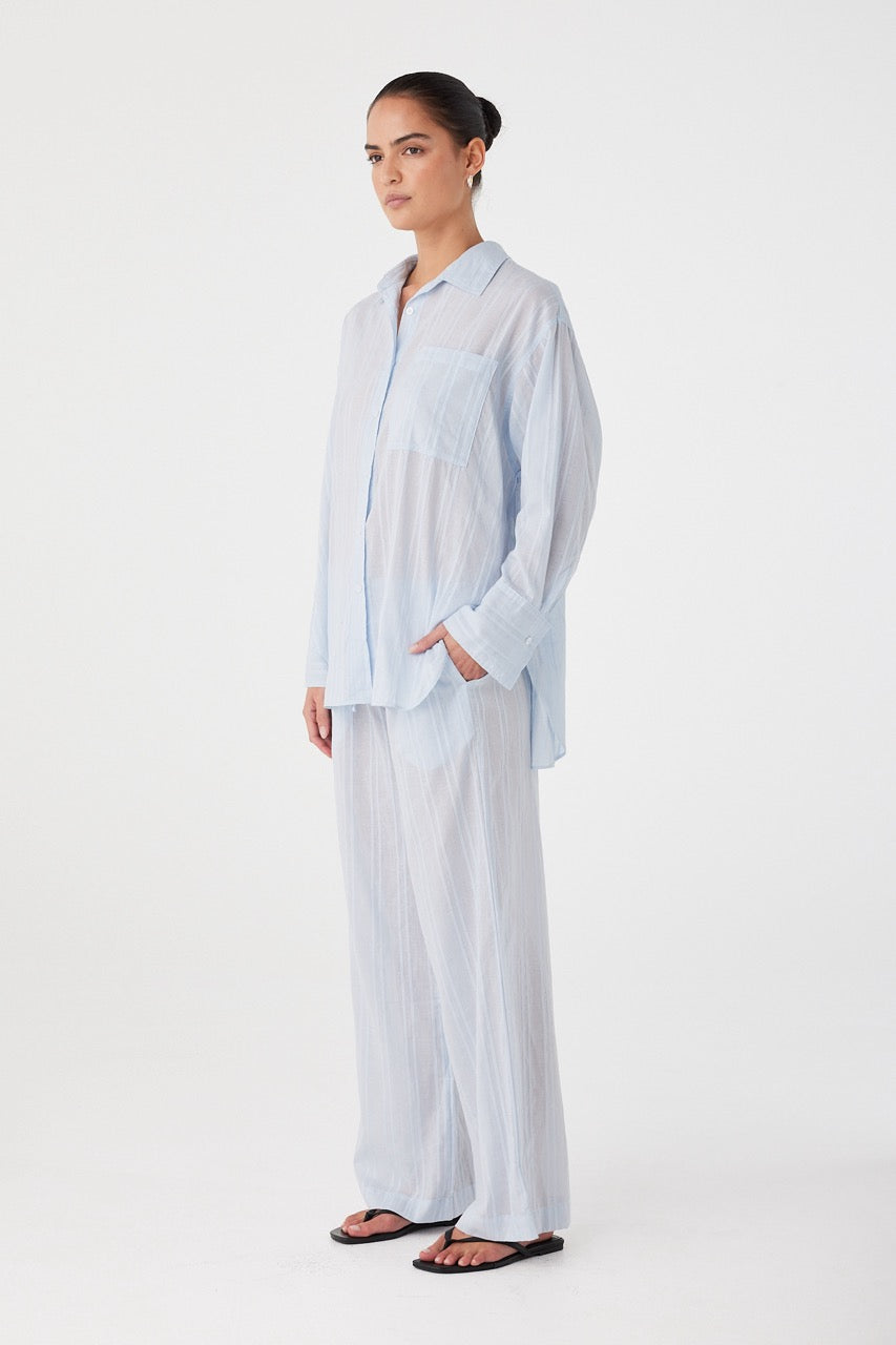 Loose-fitting shirt with long sleeves and back pleat for movement.