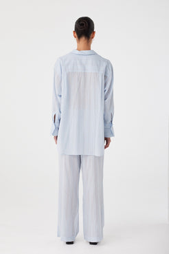 Rear view highlighting deep pleat and extended shirttail hem.