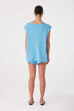 Back of lightweight relaxed shorts in breathable blend, styled loose over hips with soft hemline and summer-ready ease