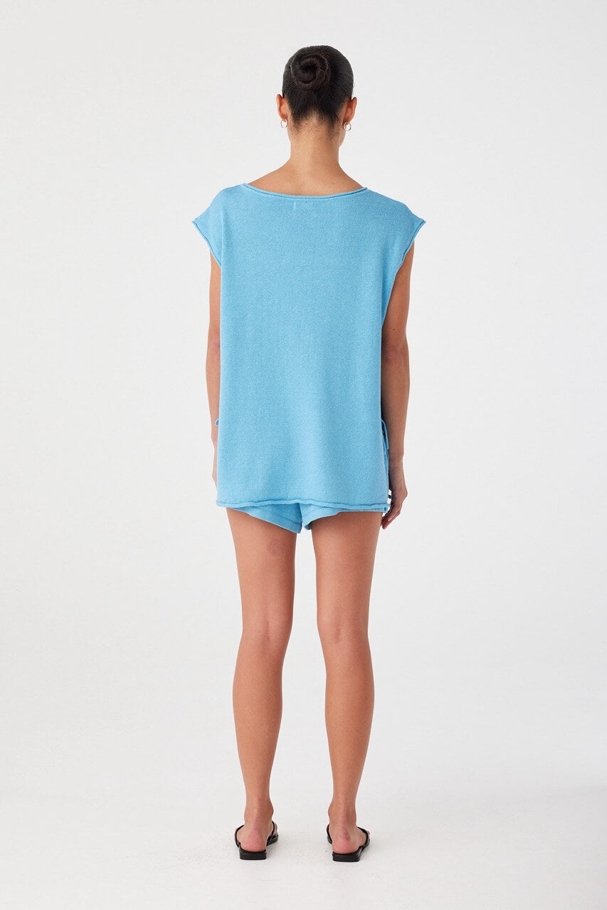 Back of lightweight relaxed shorts in breathable blend, styled loose over hips with soft hemline and summer-ready ease
