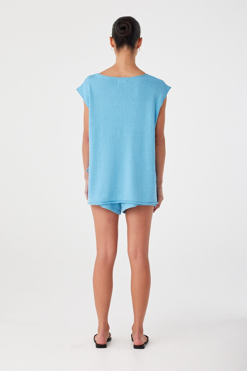 Back view of airy, oversized tank with rolled trim and relaxed silhouette.