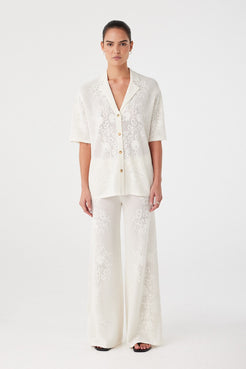 Relaxed-fit crochet shirt and matching trousers styled together. Lightweight texture ideal for layering or standalone wear in summer.