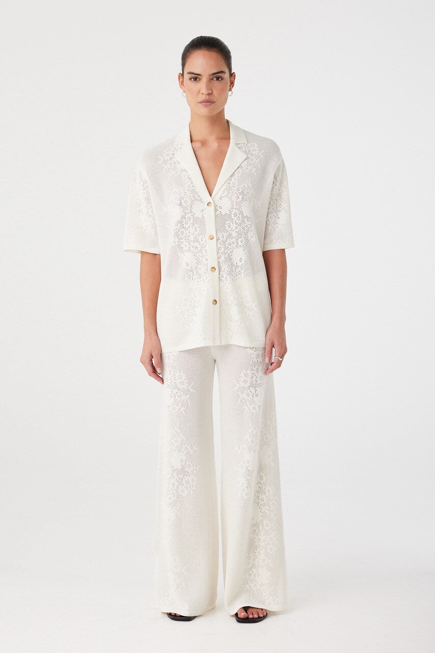 Relaxed-fit crochet shirt and matching trousers styled together. Lightweight texture ideal for layering or standalone wear in summer.