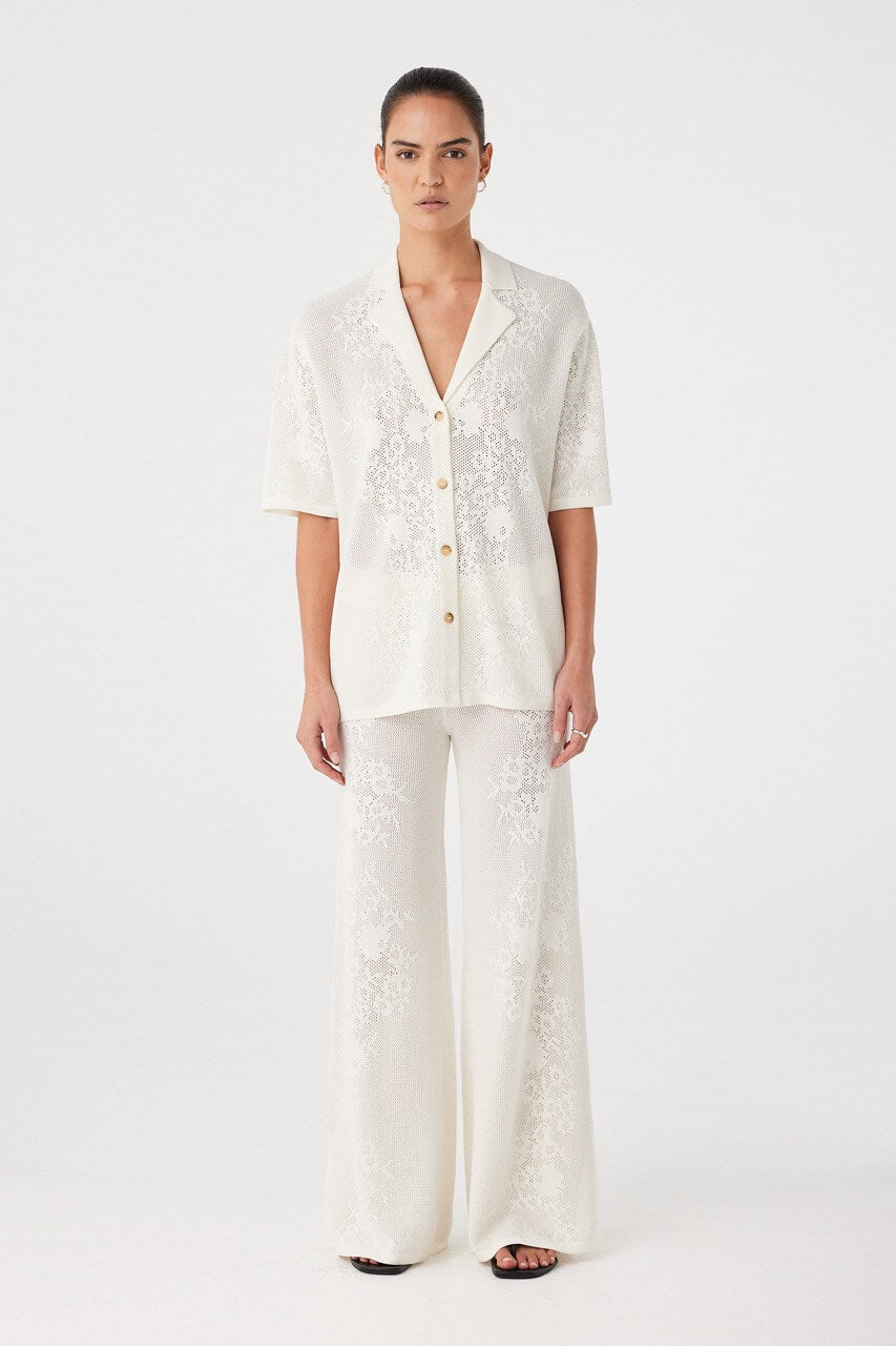 Model wearing full-length crochet pants in a cream hemp cotton blend. Wide-leg silhouette with relaxed drape and breathable feel.