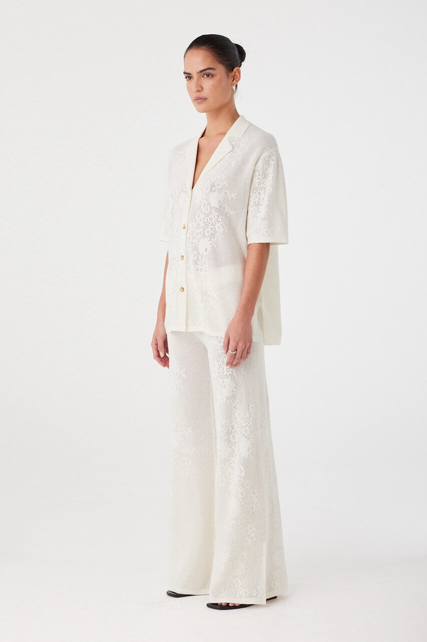 Side profile of cream crochet shirt in natural fibre blend, showing drape and sleeve length. Designed for breathable layering.