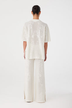 Back view of relaxed-fit shirt in custom crochet knit. Soft structure with natural movement in a hemp-cotton fabric.