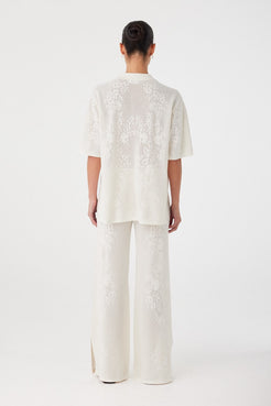 Back view of wide-leg crochet pants in custom hemp cotton knit. Relaxed cut designed for effortless summer wear.