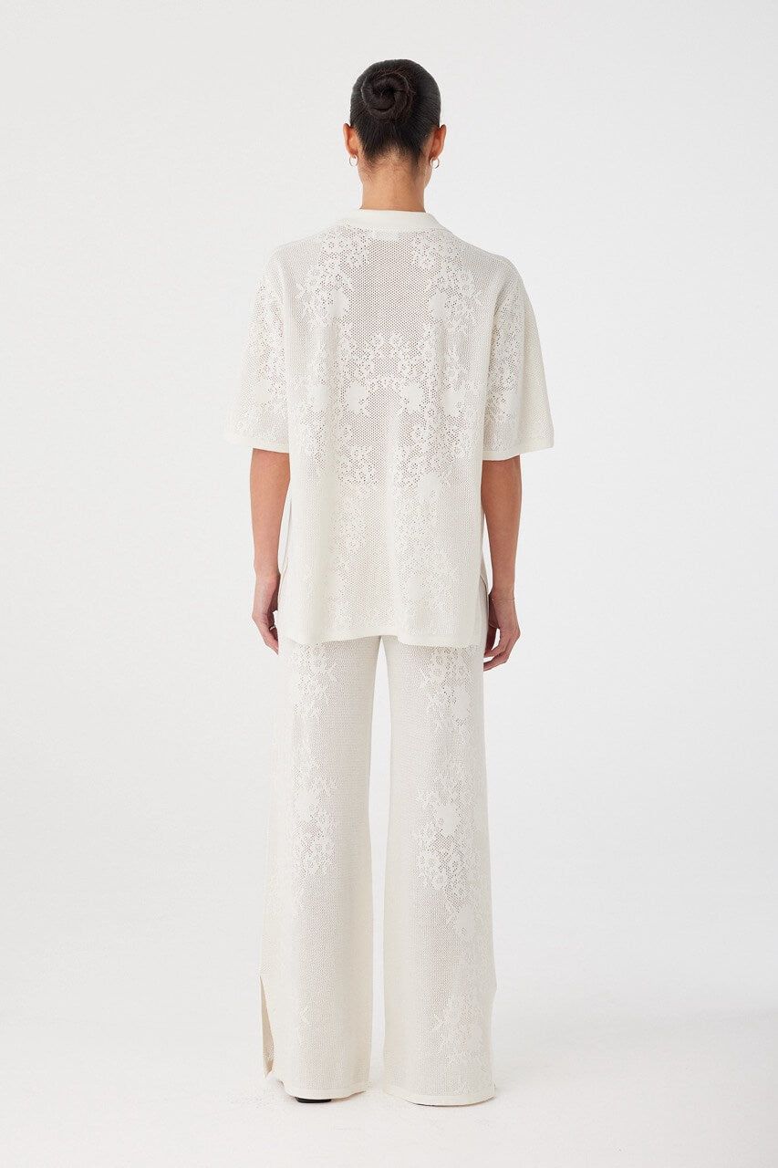 Back view of wide-leg crochet pants in custom hemp cotton knit. Relaxed cut designed for effortless summer wear.