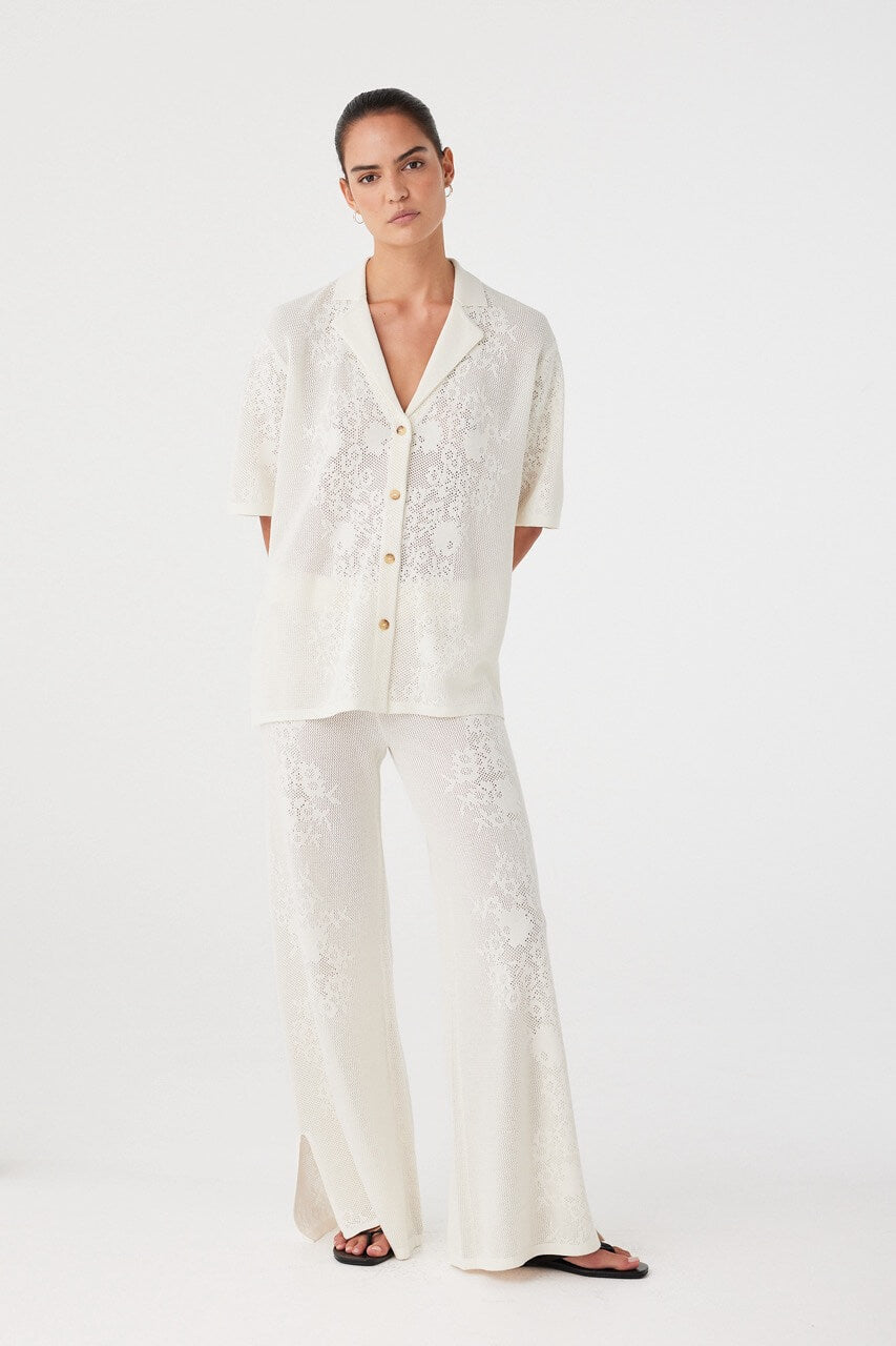 Model styled in tonal set featuring cream crochet shirt. Balanced silhouette, ideal for warm climates and elevated casual wear.