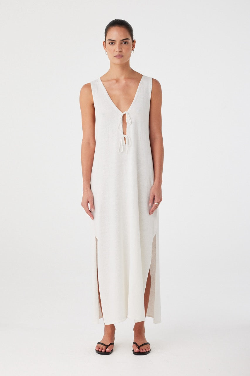 Model wears cream linen-cotton maxi dress with V neckline, relaxed fit and ankle-length hem.