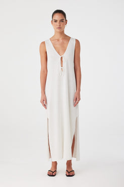 Model wears cream linen-cotton maxi dress with V neckline, relaxed fit and ankle-length hem.