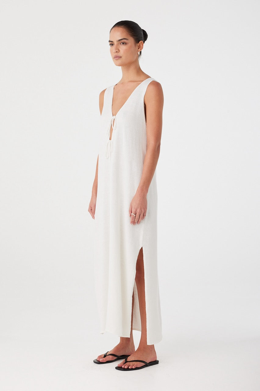 Softly draped cream maxi dress with side slit and breathable texture, ideal for summer wear.