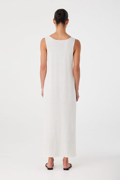 Open back cut of lightweight cream dress, crafted in a linen–cotton blend with subtle movement.