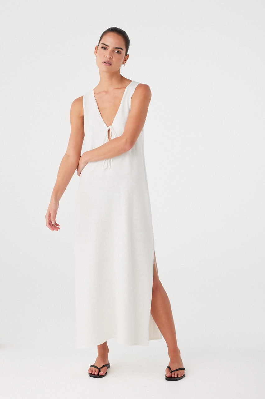 Linen-cotton maxi in cream with front tie detail, designed for warm days and travel layering.