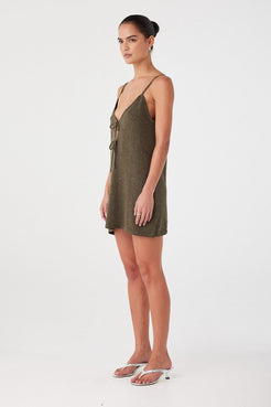 Side profile of olive sparkle mini dress showing fitted bodice and flared hem. Lightweight shimmer knit for warm weather.