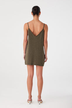 Back view of olive green mini dress in linen–cotton blend with soft shimmer. Thin straps and clean finish.