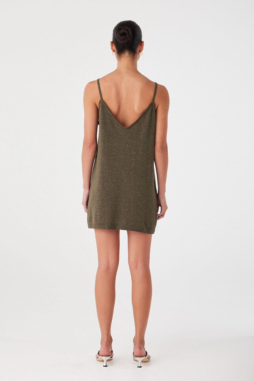 Back view of olive green mini dress in linen–cotton blend with soft shimmer. Thin straps and clean finish.