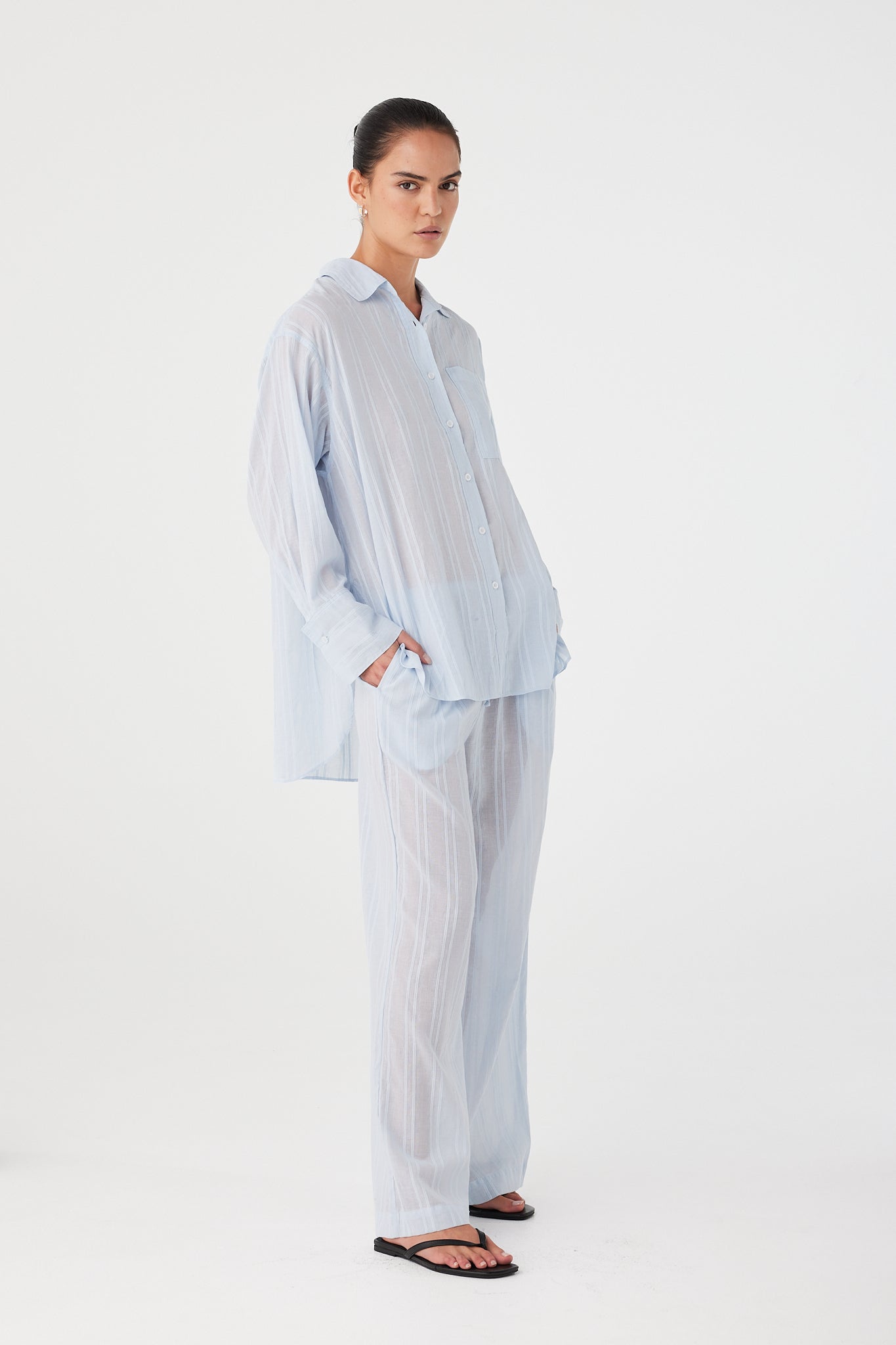 Model styling lounge-inspired pants in airy textured cotton for everyday layering.