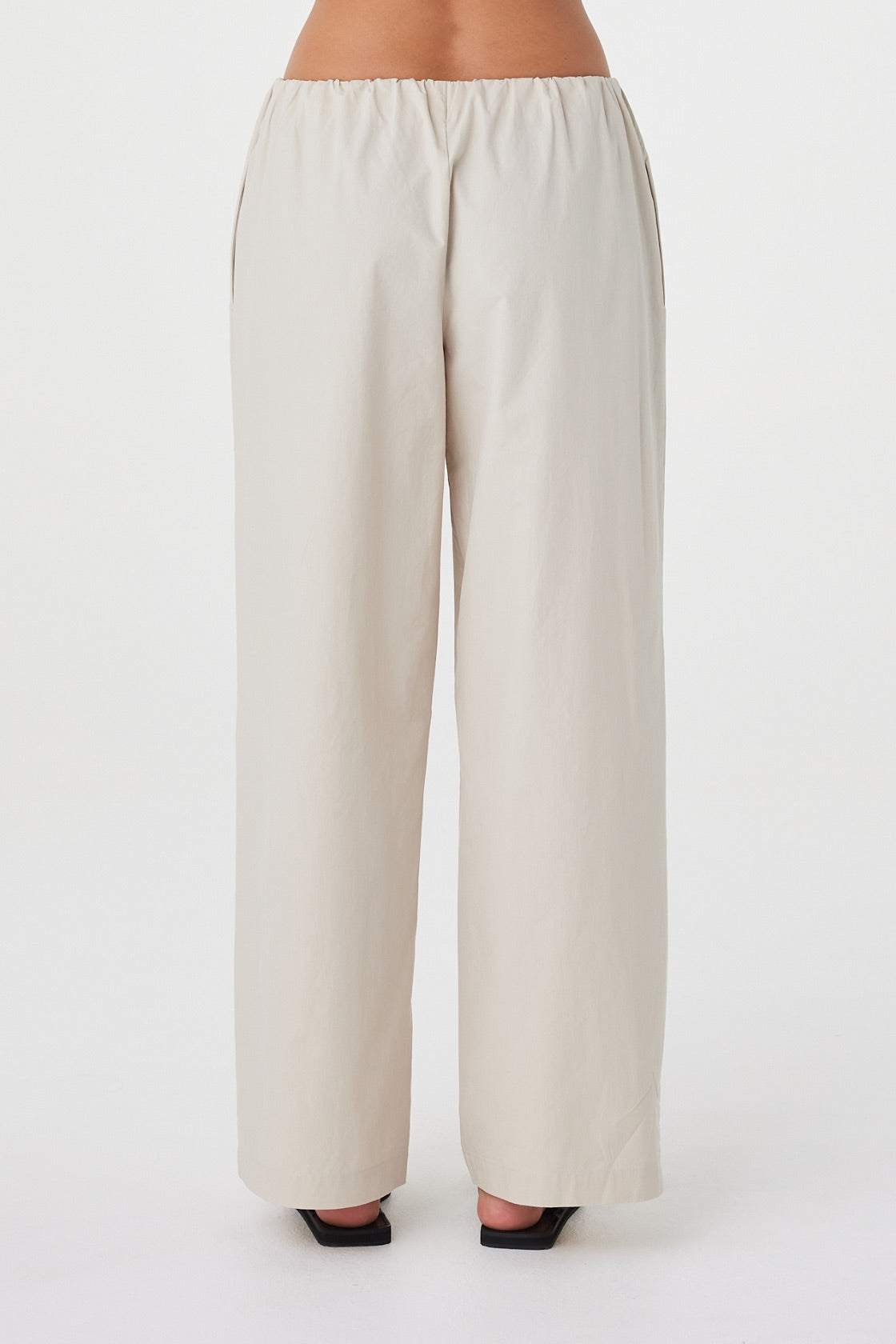 Back view of the Annika Pant in Taupe showing the functional side seam pocket and waistband construction.