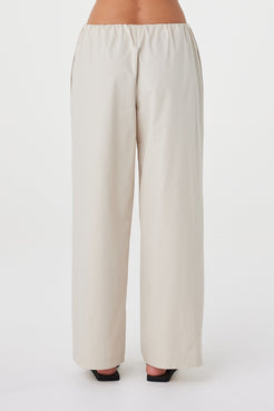 Back view of the Annika Pant in Taupe showing the functional side seam pocket and waistband construction.