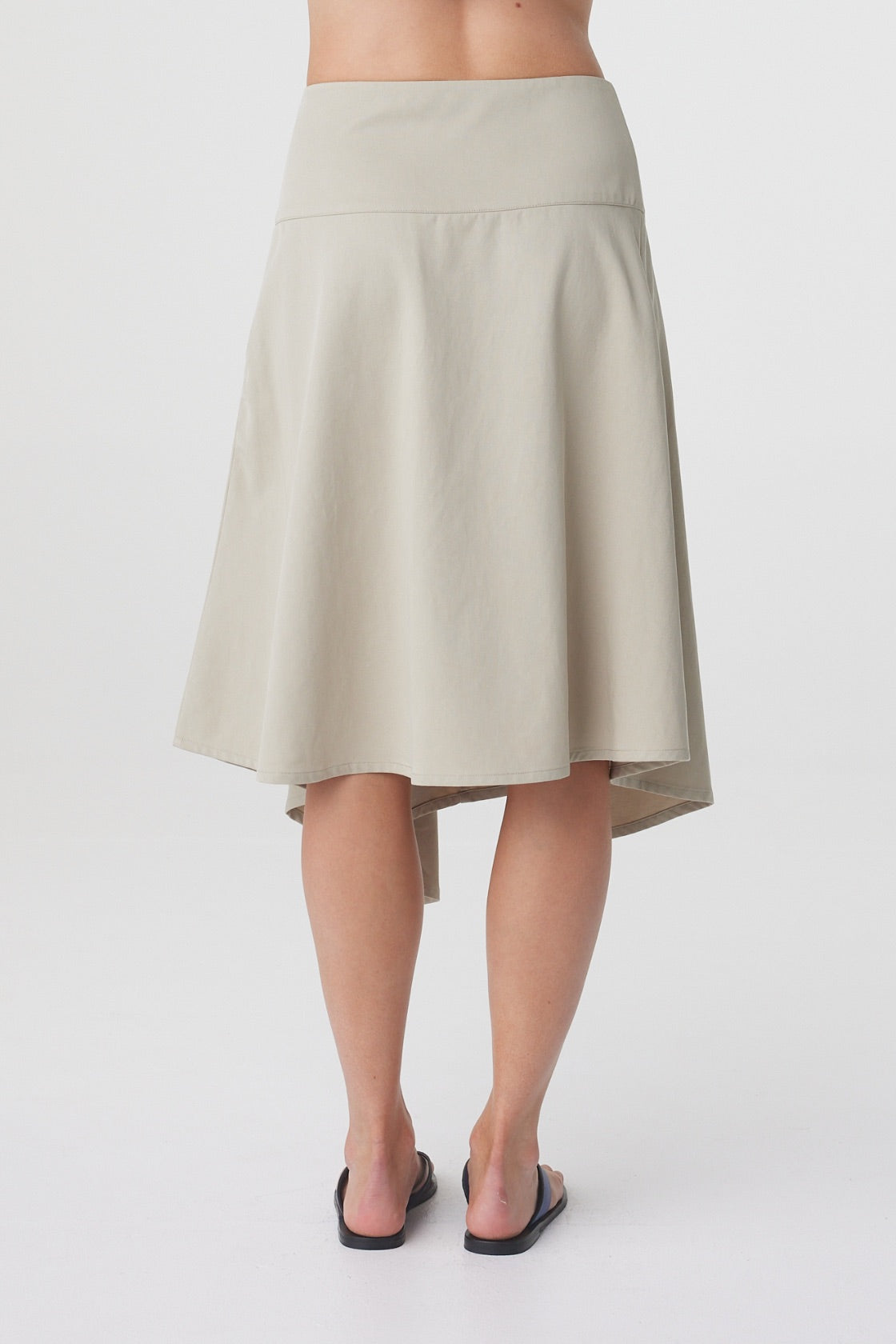 Anya Skirt in Taupe, close back view highlighting the clean waistband and godet detailing through the back.