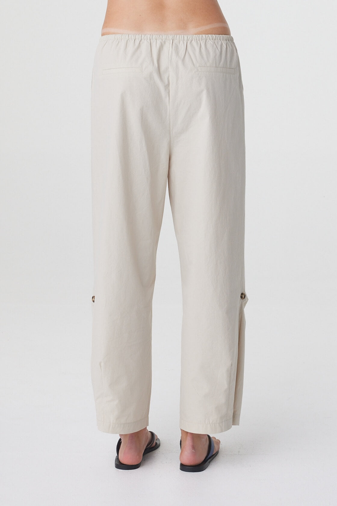 Lena Barrel Pant in Taupe, close back view showing the elasticated waistband and relaxed cropped silhouette.
