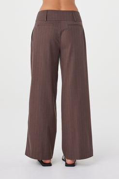 Back view of the Manon Pant in Espresso Pinstripe featuring the wide-leg fit and non-functional back welt pockets.
