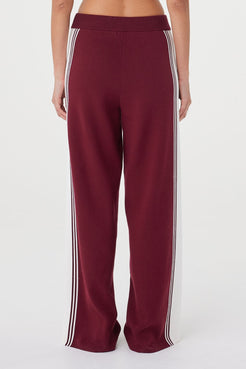 Back view of the Emery Pant in merlot featuring cream side stripe detailing and a relaxed fit through the leg
