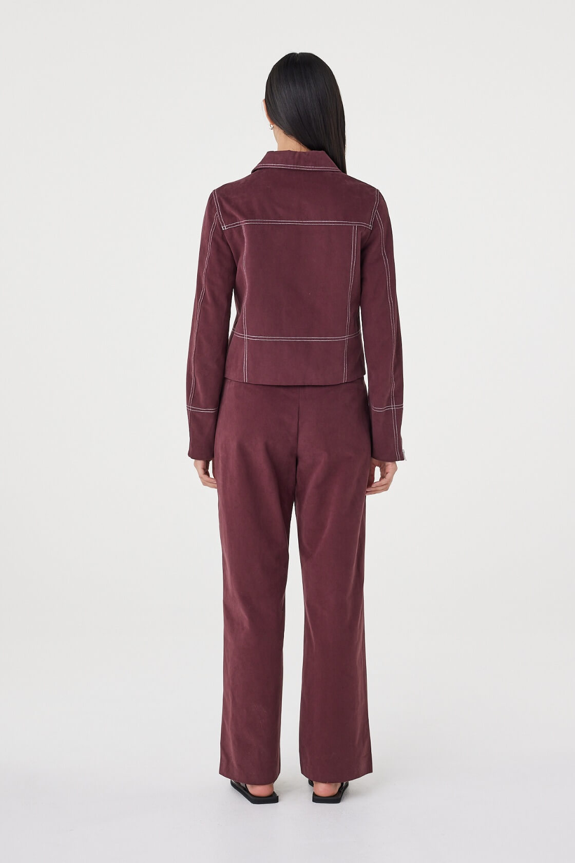Rear three-quarter view of the Avery Pant in Merlot highlighting the clean back profile and relaxed silhouette.