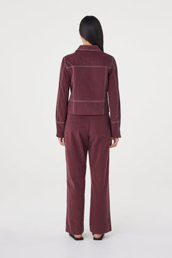 Rear three-quarter view of the Avery Pant in Merlot highlighting the clean back profile and relaxed silhouette.