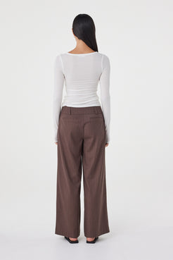 Back view of the Manon Pant in Espresso Pinstripe featuring the wide-leg fit and non-functional back welt pockets.