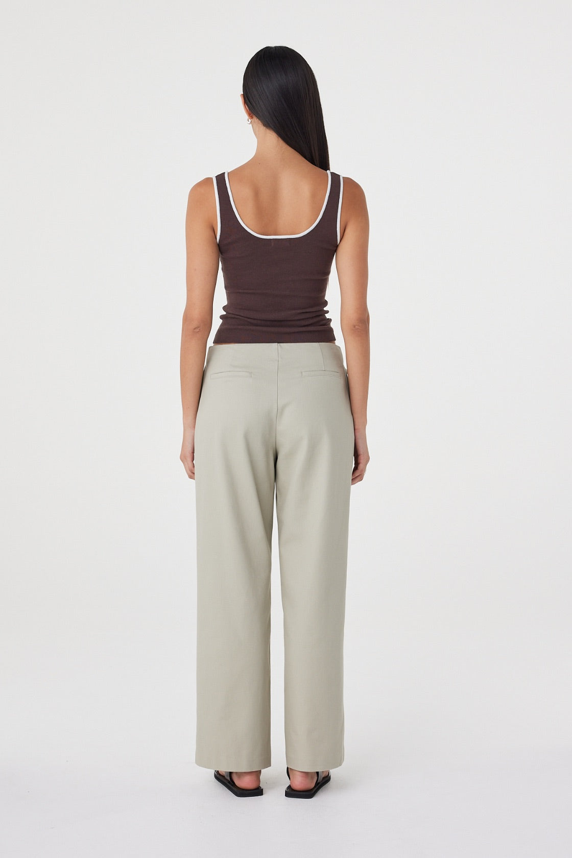 Back view of the Lucia Tie Pant in Light Sage featuring the clean back finish, non-functional welt pockets and relaxed fit.

