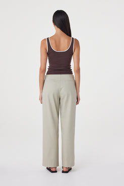 Back view of the Lucia Tie Pant in Light Sage featuring the clean back finish, non-functional welt pockets and relaxed fit.
