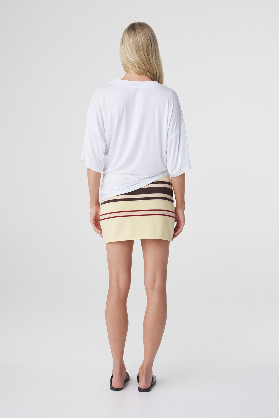 Mara Mini Skirt in Butter Espresso Stripe, back view showing the fitted shape and horizontal stripe placement.