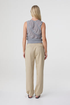 Sabi Pant in Taupe styled with a grey sleeveless top, back view showing the fit through the hips and straight leg silhouette.