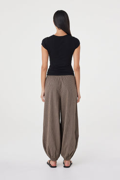 Back view of the Elina Balloon Pant in Chocolate Check featuring the elasticated back waistband, gathered volume and relaxed fit.