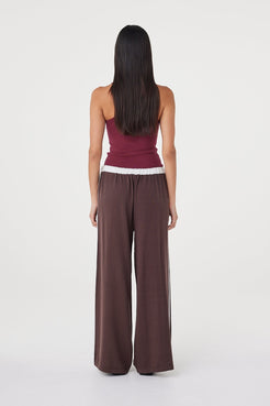 Full-length back view of the Tully Pant in espresso and cream styled with a fitted merlot ribbed tank, highlighting the relaxed fit, elasticated waistband and fluid drape through the leg