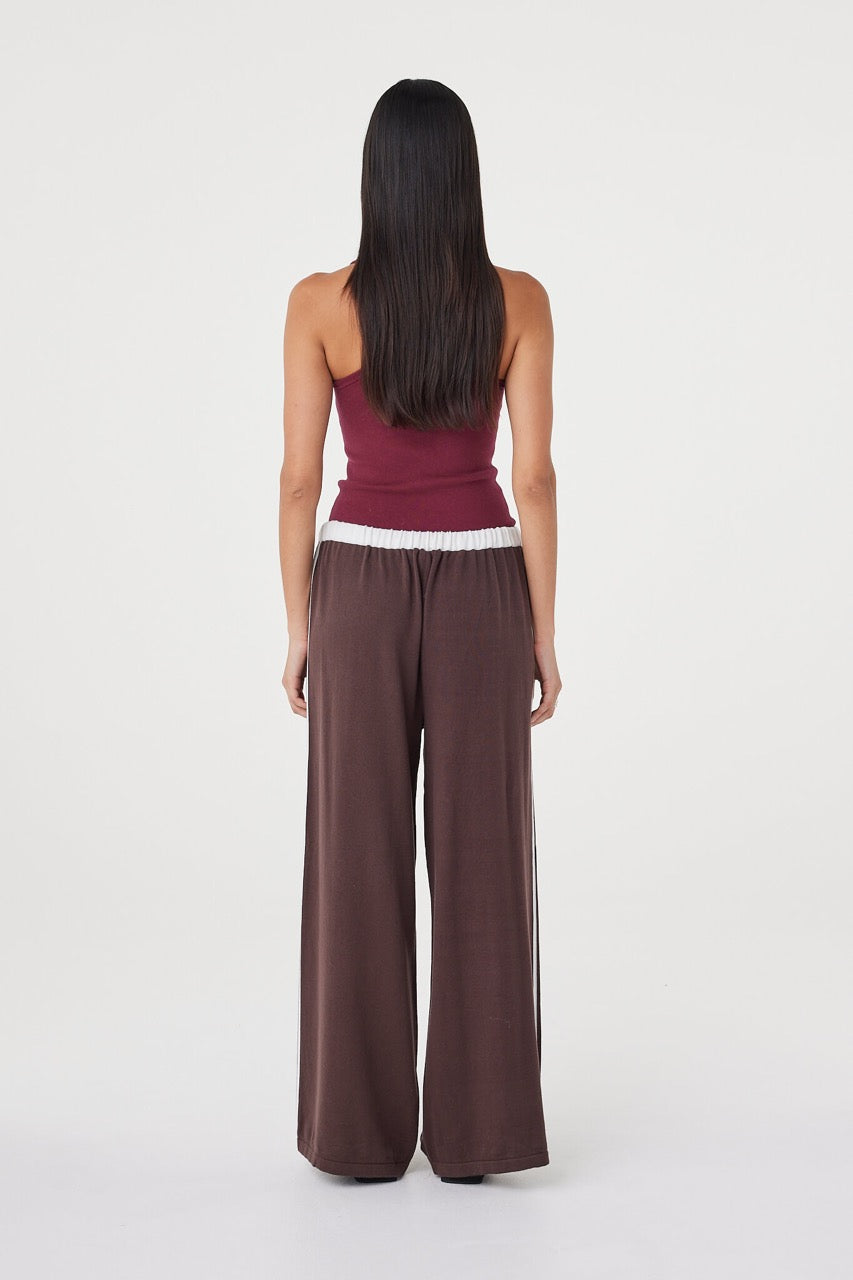 Full-length back view of the Tully Pant in espresso and cream styled with a fitted merlot ribbed tank, highlighting the relaxed fit, elasticated waistband and fluid drape through the leg