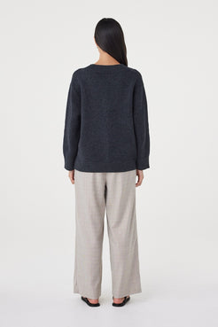 Back view of the Zenya Sweater in Dark Grey Marle featuring a relaxed silhouette, ribbed hem and marled knit texture throughout.