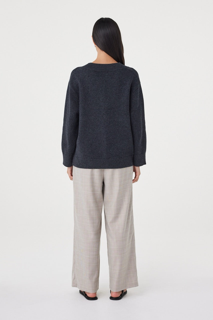 Back view of the Zenya Sweater in Dark Grey Marle featuring a relaxed silhouette, ribbed hem and marled knit texture throughout.