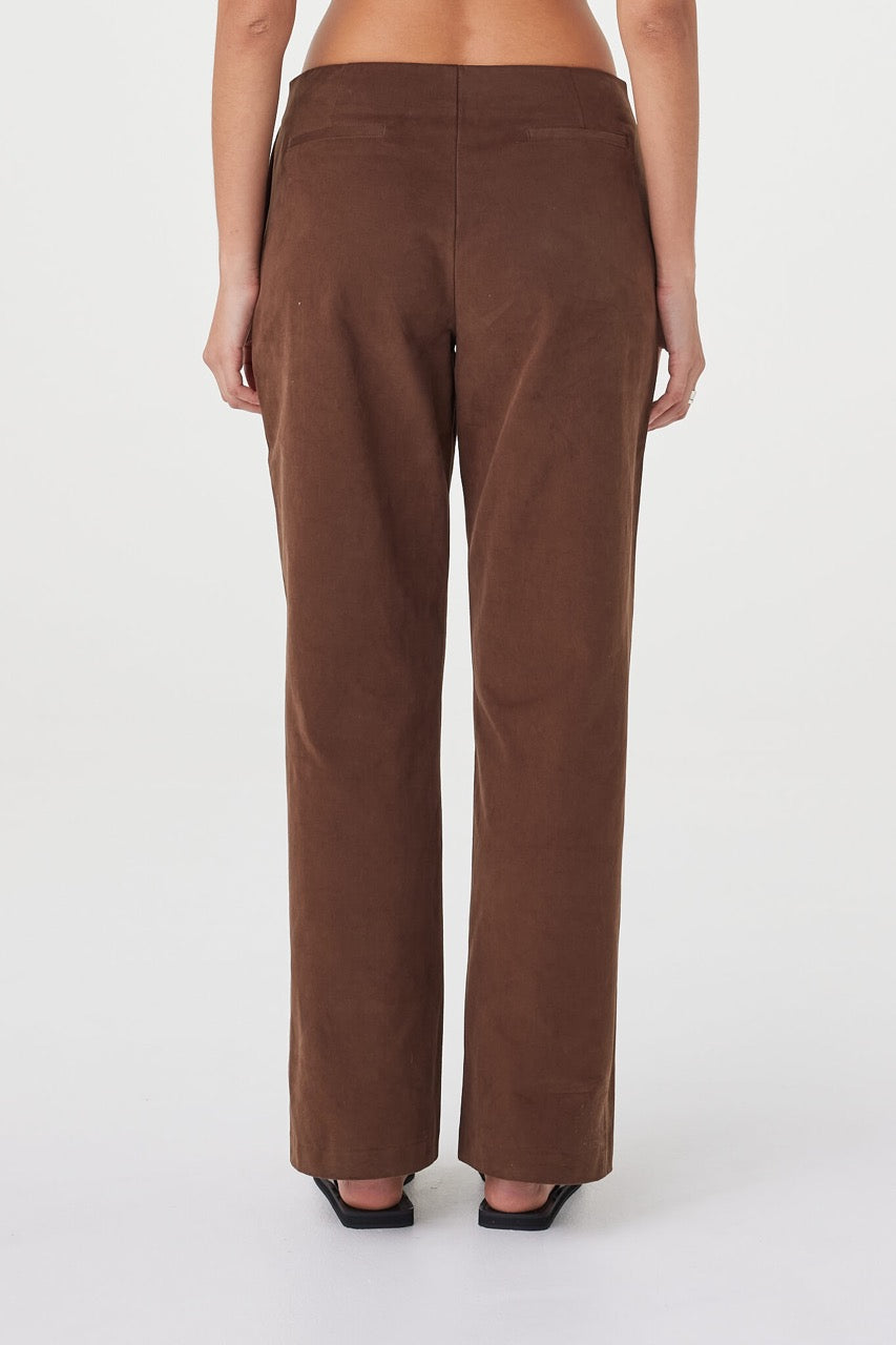 Close-up back view of the Avery Pant in espresso highlighting the velvet-textured cotton fabrication, clean waist finish and subtle tailored detailing through the back