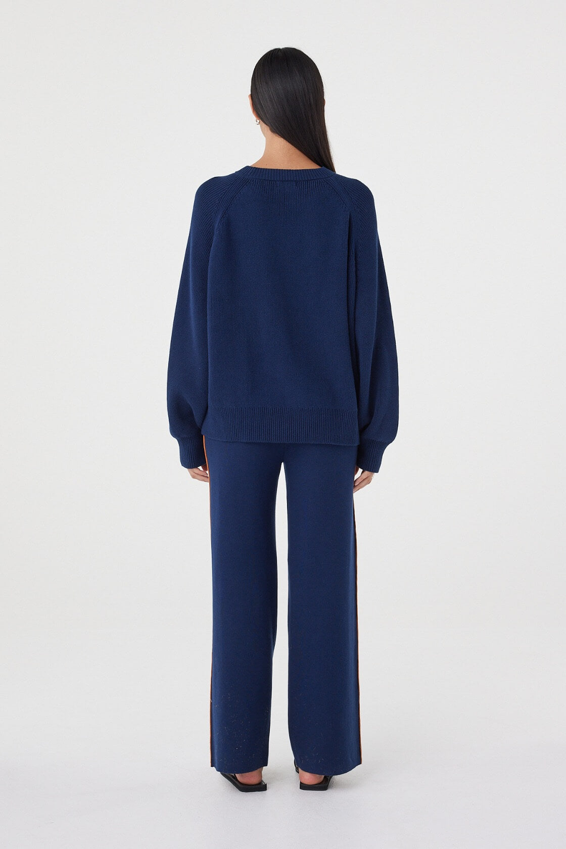 Back view of the Aubrey Sweater in Navy featuring a relaxed silhouette, ribbed hem detailing and soft knit construction.